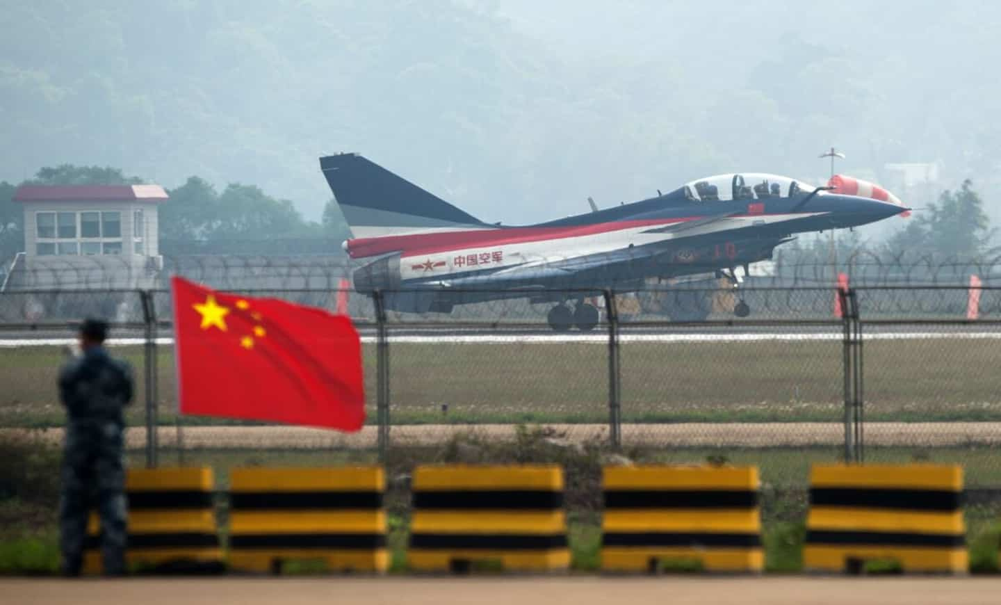 China: military plane crashes into homes, at least one dead