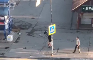 In Russia, pro-Putin destroy signs in the colors of...