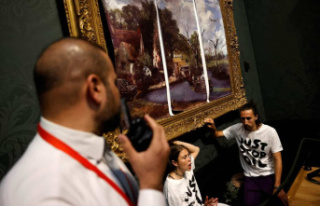 [PHOTOS] Environmental activists stick to a painting...